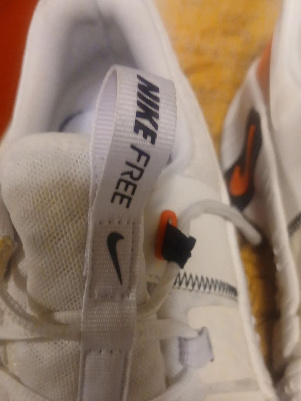 Nike Men’s White Athletic Shoes with Orange and Black Accents